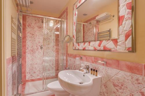 a bathroom with a sink and a shower and a toilet at La Casa Del Garbo - Luxury Rooms & Suite in Florence
