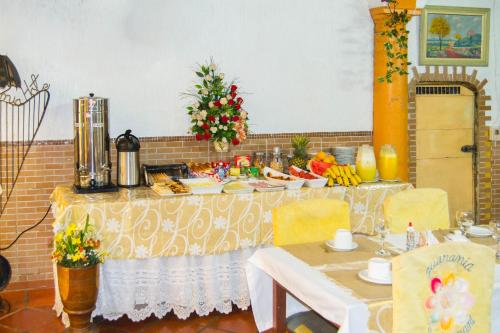 a table with food and a christmas tree on it at Hotel & Restaurante Guarania in Ciudad del Este