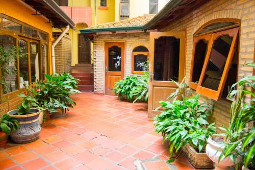 a brick house with a patio with plants on it at Hotel & Restaurante Guarania in Ciudad del Este