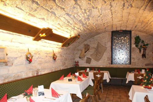 a dining room with white tables and christmas decorations at Hotel-Restaurant und Gästehaus Löwen in Süßen