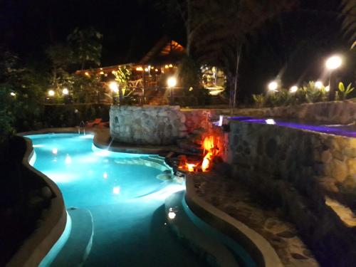 a swimming pool at night with lights at Finca de la Vaca - Family House in Mera