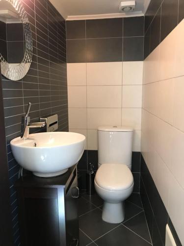a bathroom with a white toilet and a sink at Heart City Executive Suite in Chania
