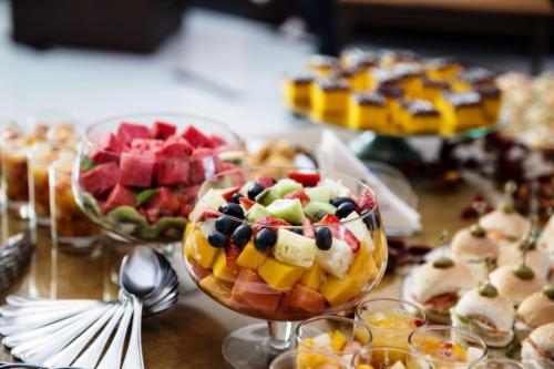 a table with a bunch of different types of food at Itu Plaza Hotel in Itu