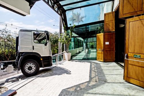 a white truck parked outside of a building at Itu Plaza Hotel in Itu