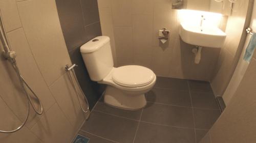 a bathroom with a toilet and a sink at U Design Hotel Kuala Lipis in Kuala Lipis