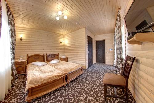 a bedroom with a bed in a wooden room at Alpin Hotel in Bukovel