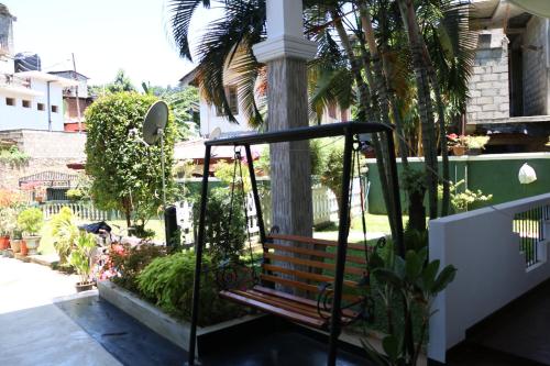 a swing on a porch in a garden at Kandy City Village in Kandy