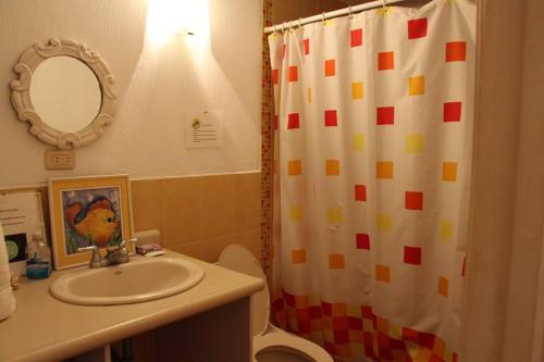a bathroom with a sink and a shower curtain at Casa San José in El Conacaste