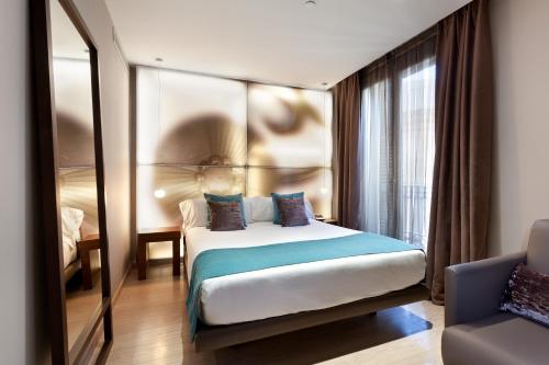 Letto o letti in una camera di Hotel España Ramblas
