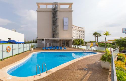 a large swimming pool in front of a building at Flag Hotel Valencia Florazar in Massalfassar