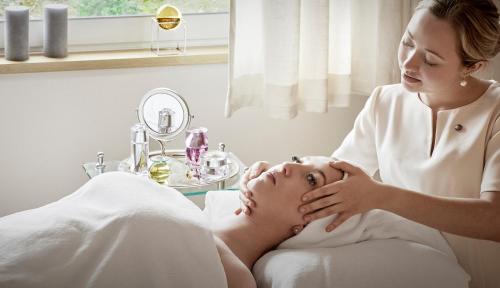 a woman in a spa getting her face massage at Château Saint-Martin & Spa, Oetker Hotels in Vence