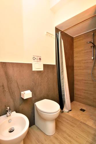 a bathroom with a toilet and a sink at Modica Old Town Rooms in Modica