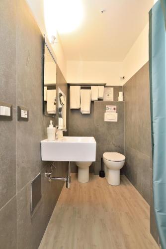 a bathroom with a sink and a toilet at Modica Old Town Rooms in Modica