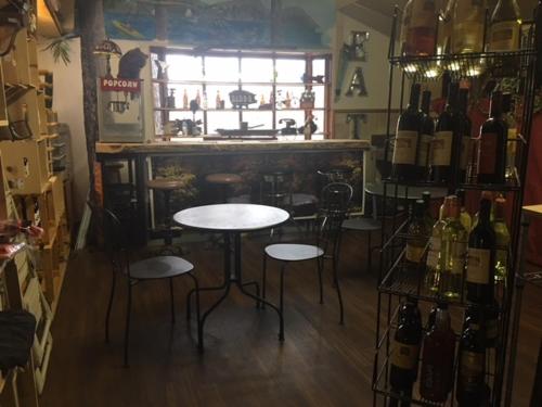 a bar with two tables and chairs and bottles of wine at Cabins 4 Less, No Fees in Big Bear Lake