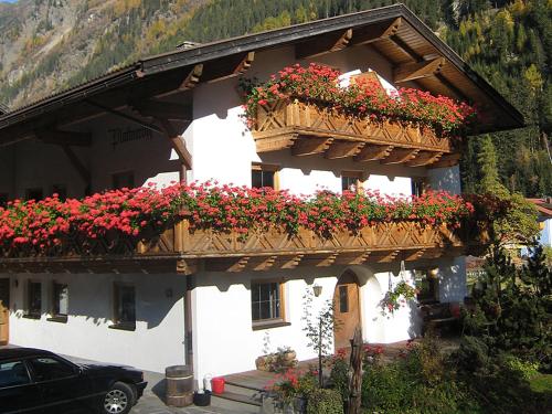 a building with flower boxes on the side of it at Plattnerhof Kaunertal in Kaunertal