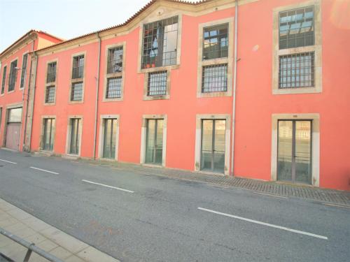 an orange building on the side of a street at LUXURY VIEWS by YoursPorto in Vila Nova de Gaia