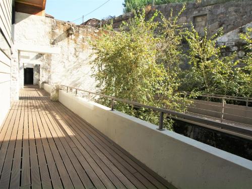 a wooden walkway next to a wall with stairs at LUXURY VIEWS by YoursPorto in Vila Nova de Gaia