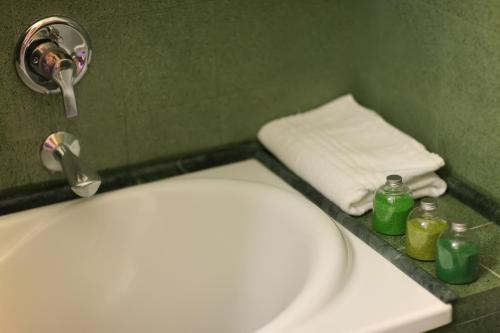 a bathroom with a toilet and a sink and towels at Hotel Zeffiro in Sabaudia