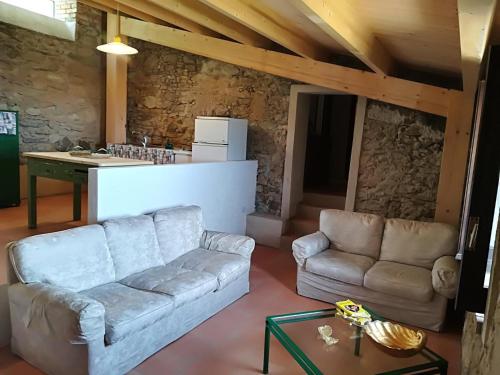 a living room with a couch and a table at Il Cerro Agriturismo Zagarese in Fuscaldo