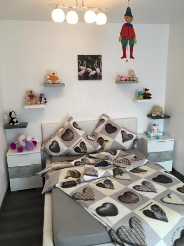 a bedroom with a bed with black and white pillows at Ana‘s Ferienwohnung in Furth im Wald