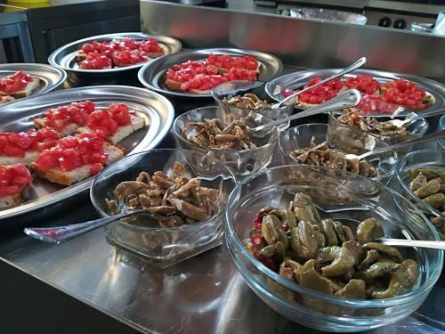 a buffet with many different types of food in bowls at Il Cerro Agriturismo Zagarese in Fuscaldo