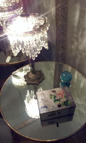 a glass table with a chandelier and a box on it at Whatever Art B&B in Lisbon
