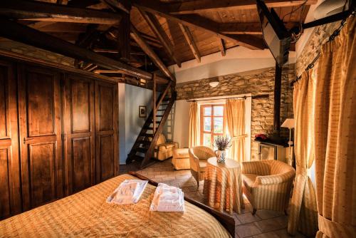 a bedroom with a bed and a table and chairs at Agriturismo Gallo in Cortemilia