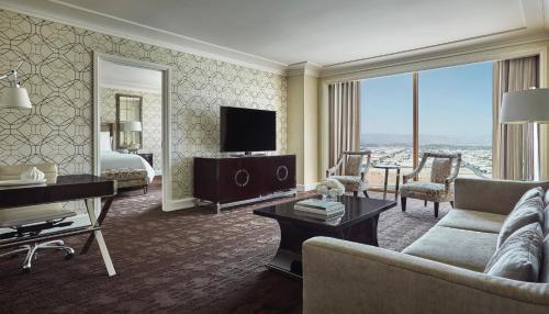 a living room with a couch and a television at Four Seasons Hotel Las Vegas in Las Vegas