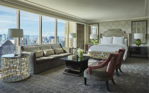 a hotel room with a bed and a large window at Four Seasons Hotel Las Vegas in Las Vegas