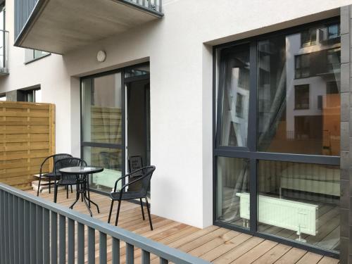 a balcony with black chairs and a table at Near Ozas in Vilnius