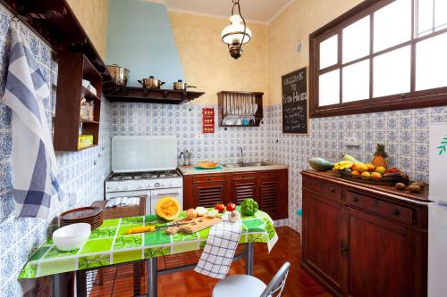 a kitchen with a table with fruits and vegetables on it at Patio Hostel in La Laguna