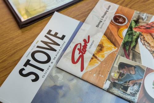 two magazines sitting on top of a table at Commodores Inn in Stowe
