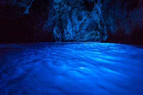 a blue pool of water in a cave at Villa Nora Hvar in Hvar