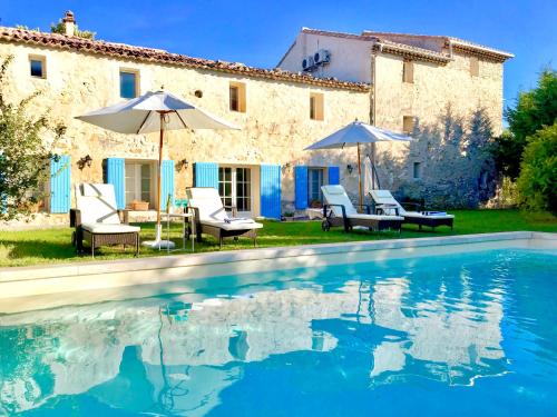 a villa with a swimming pool in front of a house at Domaine de La Brave in Pernes-les-Fontaines