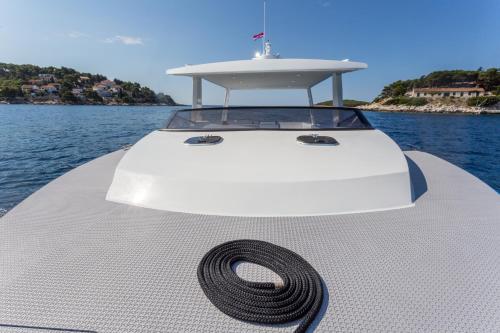 a white boat with a hose on the front at Villa Nora Hvar in Hvar