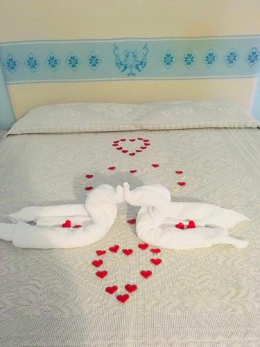 a bed with two towels and hearts on it at Il Nuraghe del lago Coghinas in Oschiri