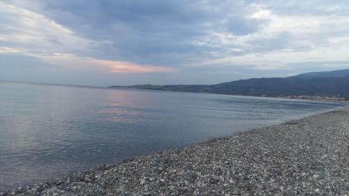 a body of water with a rocky shoreline at Camping Ulisse Calabria in Lamezia Terme