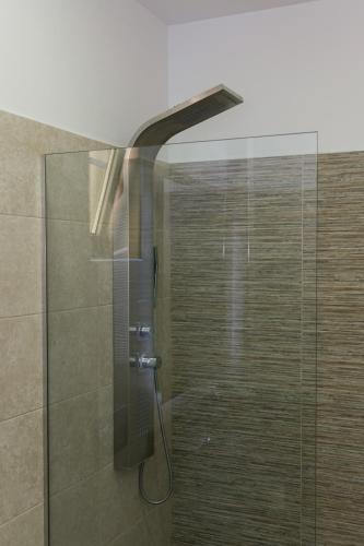 a shower with a glass door in a bathroom at Platanias Aetheras Beach in Plataniás