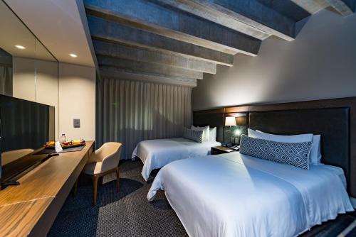 Postel nebo postele na pokoji v ubytování Movich Hotel Las Lomas