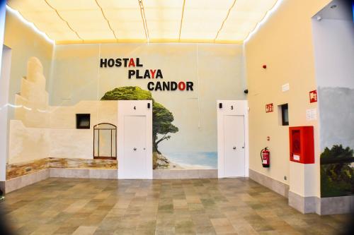 a room with a wall with a painting on it at Hostal Playa Candor in Rota