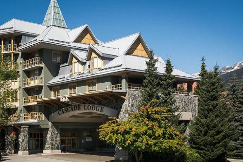 a large building with a tower on top of it at Cascade Lodge in Whistler