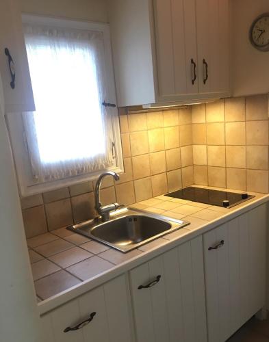 a small kitchen with a sink and a window at GKMykonos in Ano Mera
