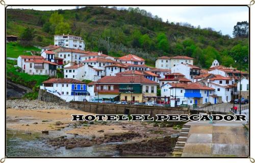 a group of houses on a hill next to a beach at Hotel El Pescador in Tazones