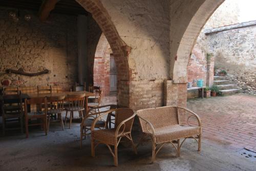 a dining room with tables and chairs in a building at Podere Calcinaia in Castelnuovo Berardenga