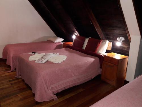 Ένα ή περισσότερα κρεβάτια σε δωμάτιο στο Petit Hotel Caraguata
