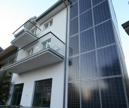 a building with a mesh fence on the side of it at Hotel Garnì Villa Maria in Riva del Garda