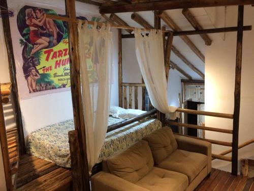a living room with a couch and a bed at Mancora Apartments in Máncora