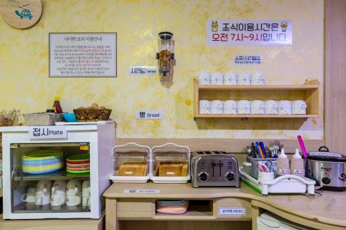 a kitchen with a counter with plates and dishes at Suanbo Saipan Hot Spring Hotel in Chungju