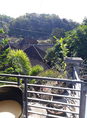a balcony with a view of a house at Bamboo Paradise in Padangbai