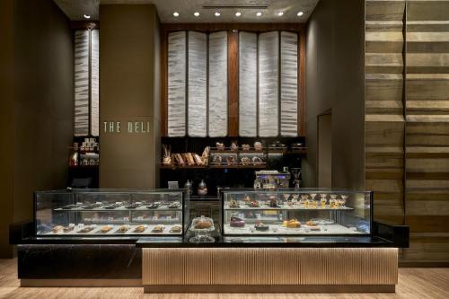 a bakery with two display cases of pastries at The Den, Bengaluru in Bengaluru